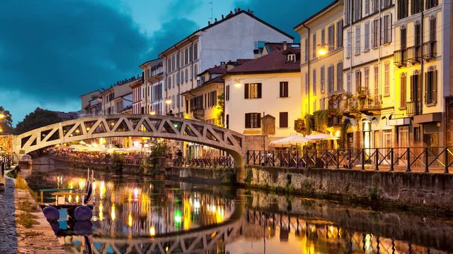 Bridge across the Naviglio Grande canal at the evening in Milan, Italy (static image with animated sky and water)
