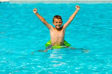 Smiling boy in swimming pool