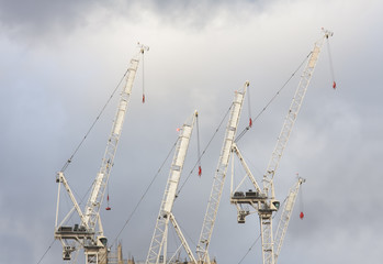 cranes for building construction with clouds in background