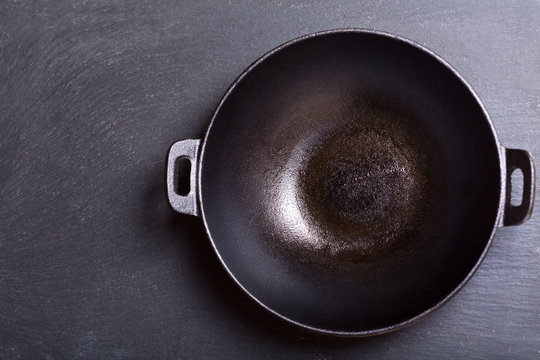empty wok in a dark background