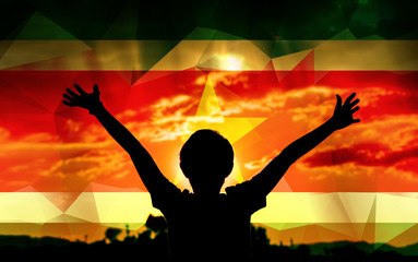 Young man raising his hands on a sunset background with a flag background - 139371654