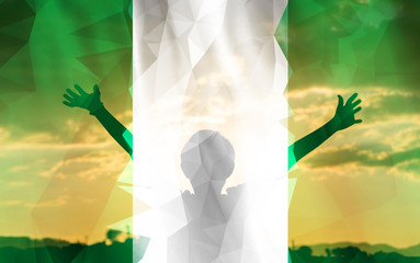 Young man raising his hands on a sunset background with a flag background - 139373015