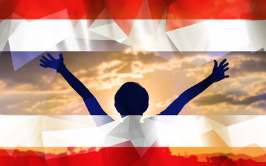 Young man raising his hands on a sunset background with a flag background - 139373477