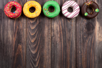glazed donuts on a black wooden background with copy space for your text. Top view
