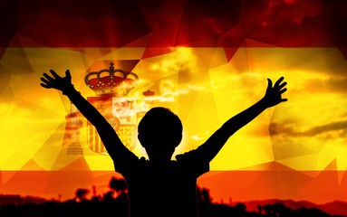 Flag of Spain with a sky background and a young man raising hands. - 139375045