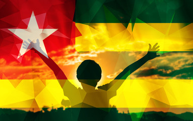 Young man raising his hands on a sunset background with a flag background - 139375234