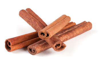 four cinnamon sticks isolated on white background