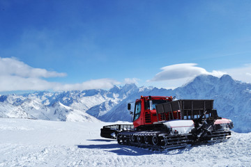 snowcat or piste machine standing on a ski slope.
