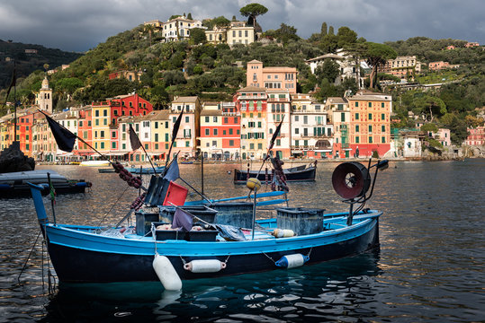 Traditional wooden fishing boat moored at port of Portofino town in Liguria district, Italy