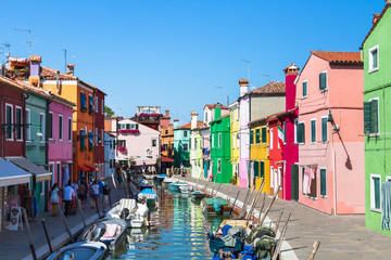 colorful street of Burano island, canal in Venice, multicolored houses in Italy