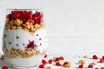 diet dessert with yogurt, granola and pomegranate fruit