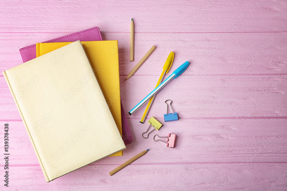 Sticker Colorful notebooks on wooden background