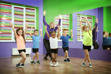 Dance teacher and children in choreography class
