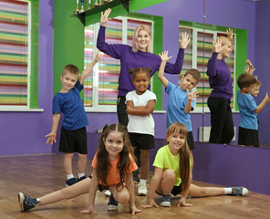 Dance teacher and children in choreography class