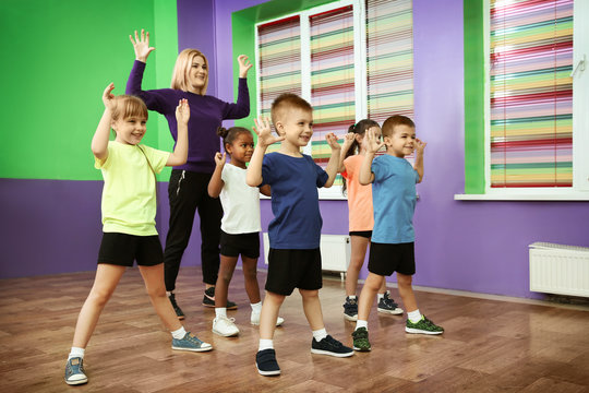 Dance teacher and children in choreography class