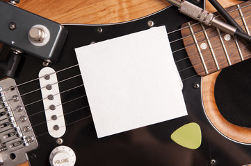 Blank paper with electric guitar. Use for music application or poster.
