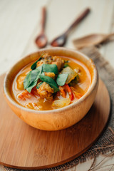 Vintage style Thai traditional food style spicy muslim curry (Massaman chicken curry) on wooden background wallpaper focus one point shallow with depth of field