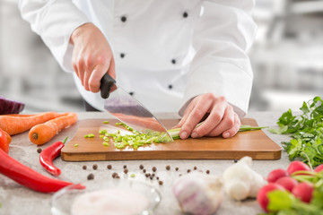 The chef slicing vegetables.