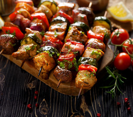 Grilled skewers with vegetables and meat in a herb marinade on a dark wooden table