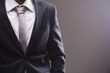 Closeup portrait of businessman in white collar shirt and suit with tie.
