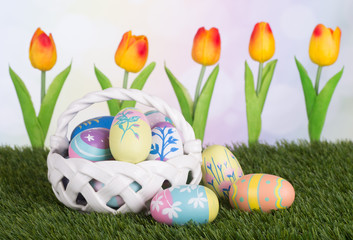 Basket Of Colorful Easter Eggs With Tulips in Background