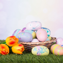Fototapeta na wymiar Basket Of Colorful Easter Eggs on a Multicolored Background