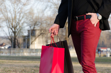 male hand holding a shopping bag