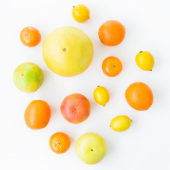 Citrus fruits pattern made of lemon, orange, grapefruit, sweetie and pomelo on white background. Flat lay, top view. Fruit background