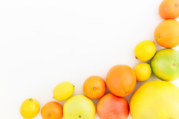 Fruits frame of lemon, orange, grapefruit, sweetie and pomelo on white background. Flat lay, top view. Fruit's background