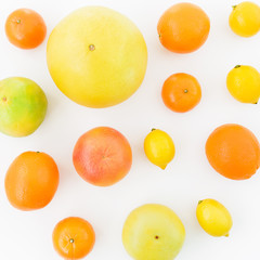 Fruits pattern made of lemon, orange, grapefruit, sweetie and pomelo on white background. Flat lay, top view. Fruit background