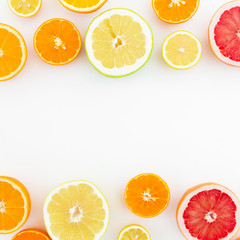 Fruits frame made of lemon, orange, grapefruit, sweetie and pomelo on white background. Flat lay, top view. Fruit's background