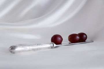 silver knife and grapes