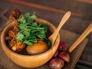 Vintage style Thai traditional and Chinese food Hard boiled egg, Golden brown egg with chicken leg on top with vintage wooden background wallpaper