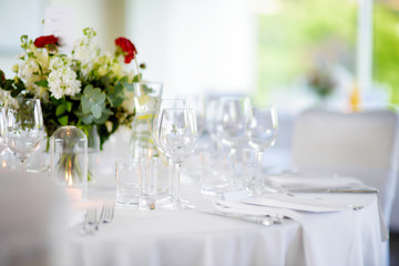Beautiful table setting with crockery and flowers for a party, wedding reception or other festive event