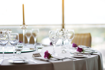 Beautiful table setting with crockery and flowers for a party, wedding reception or other festive event