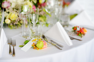 Beautiful table setting with crockery and flowers for a party, wedding reception or other festive...