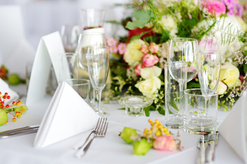 Beautiful table setting with crockery and flowers for a party, wedding reception or other festive event