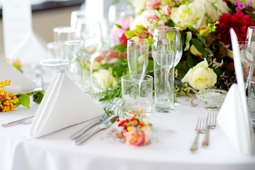 Beautiful table setting with crockery and flowers for a party, wedding reception or other festive event