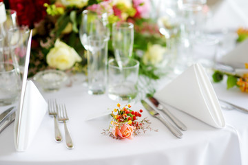 Beautiful table setting with crockery and flowers for a party, wedding reception or other festive event