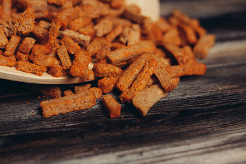 crackers with spices on a wooden plate and background...