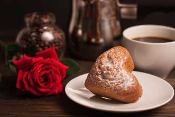 a saucer with a cupcake and a flower with a cup