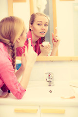 Obraz na płótnie Canvas Woman applying moisturizing skin cream. Skincare.