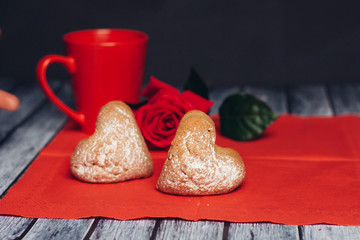 Red mug, flower and muffins on a napkin