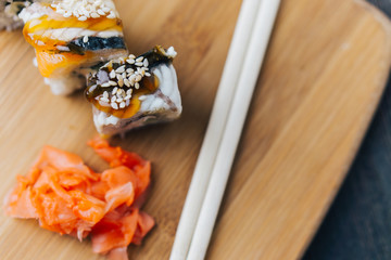 sushi, rolls, ginger on a wooden background