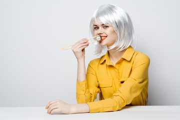 woman sit with rolls sushi 