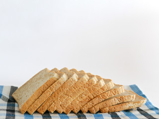 Sliced bread on white background. Sliced homemade bread. Whole grain or whole wheat bread.