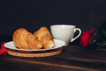 Biscuits, sweets, coffee mug tea on the table, croissant
