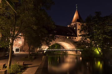 Nuremberg, Germany old town on the Pegnitz River. Castle  wall night, night bridge