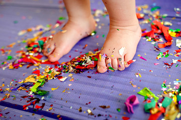children's birthday party. bare feet are on the floor with confetti