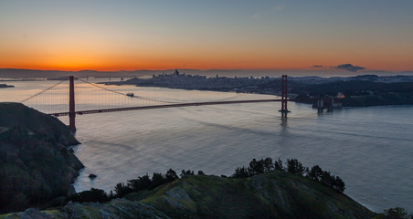 Sunrising over the San Frascisco Golden Gate Bridge with Hiils in the foreground